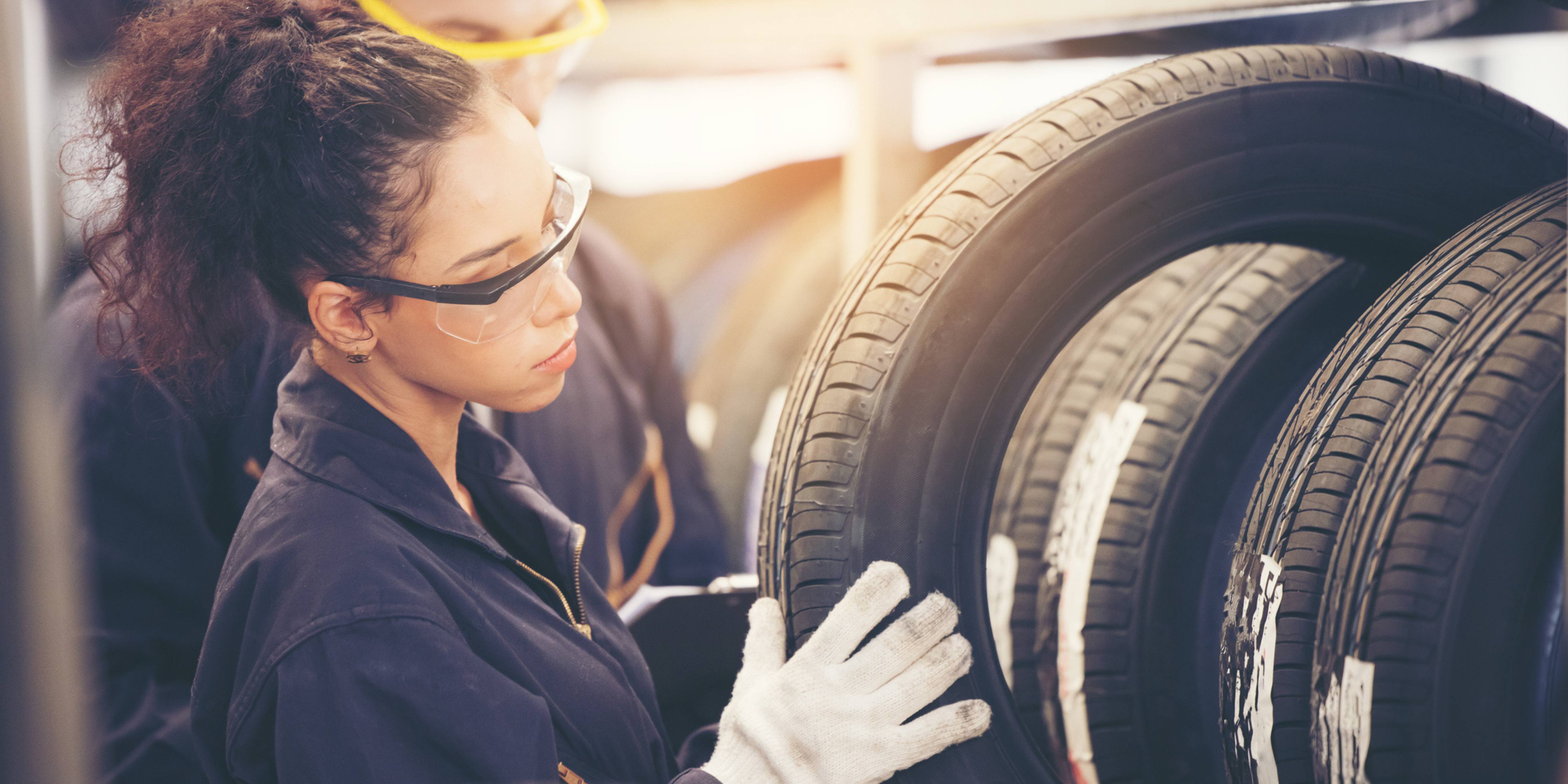 Image of a seasonal worker looking at tires