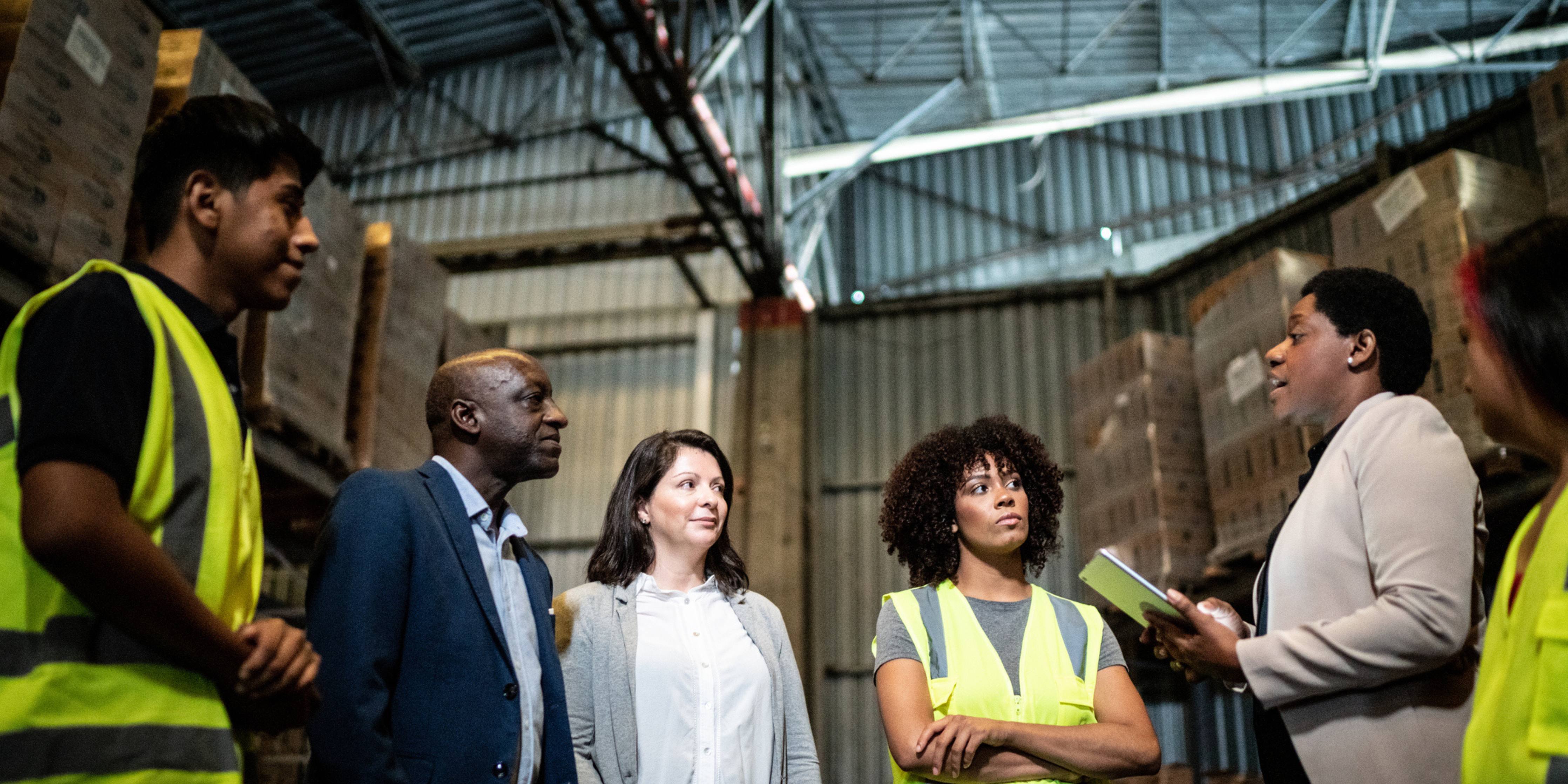 Image of a group talking in a warehouse