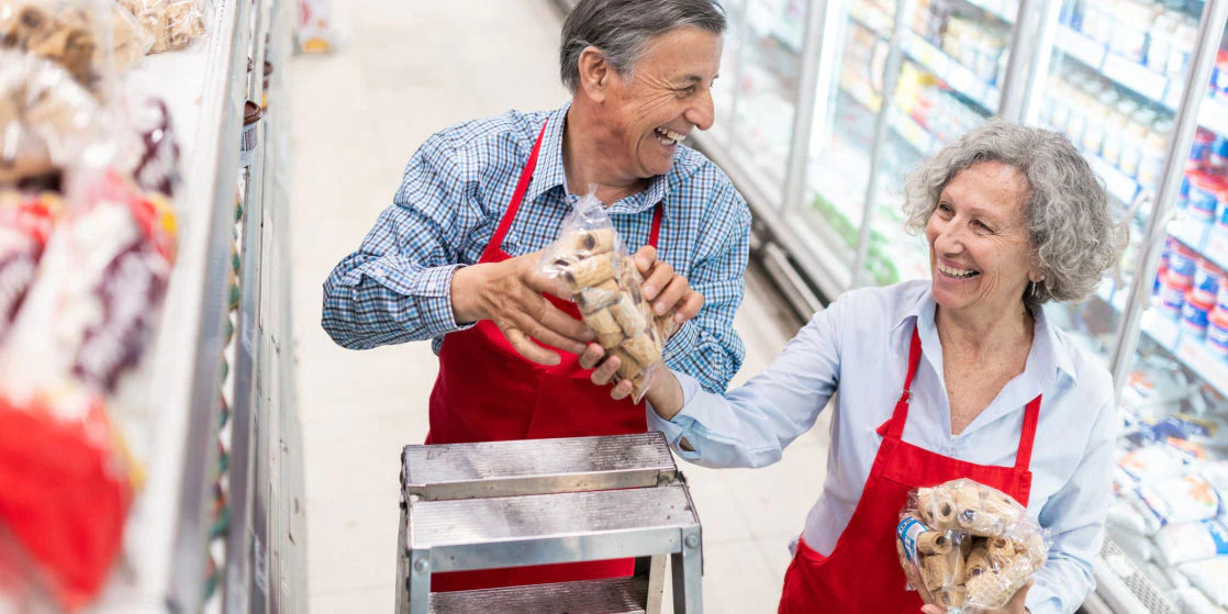 Image of workers stacking shelves using a ladder