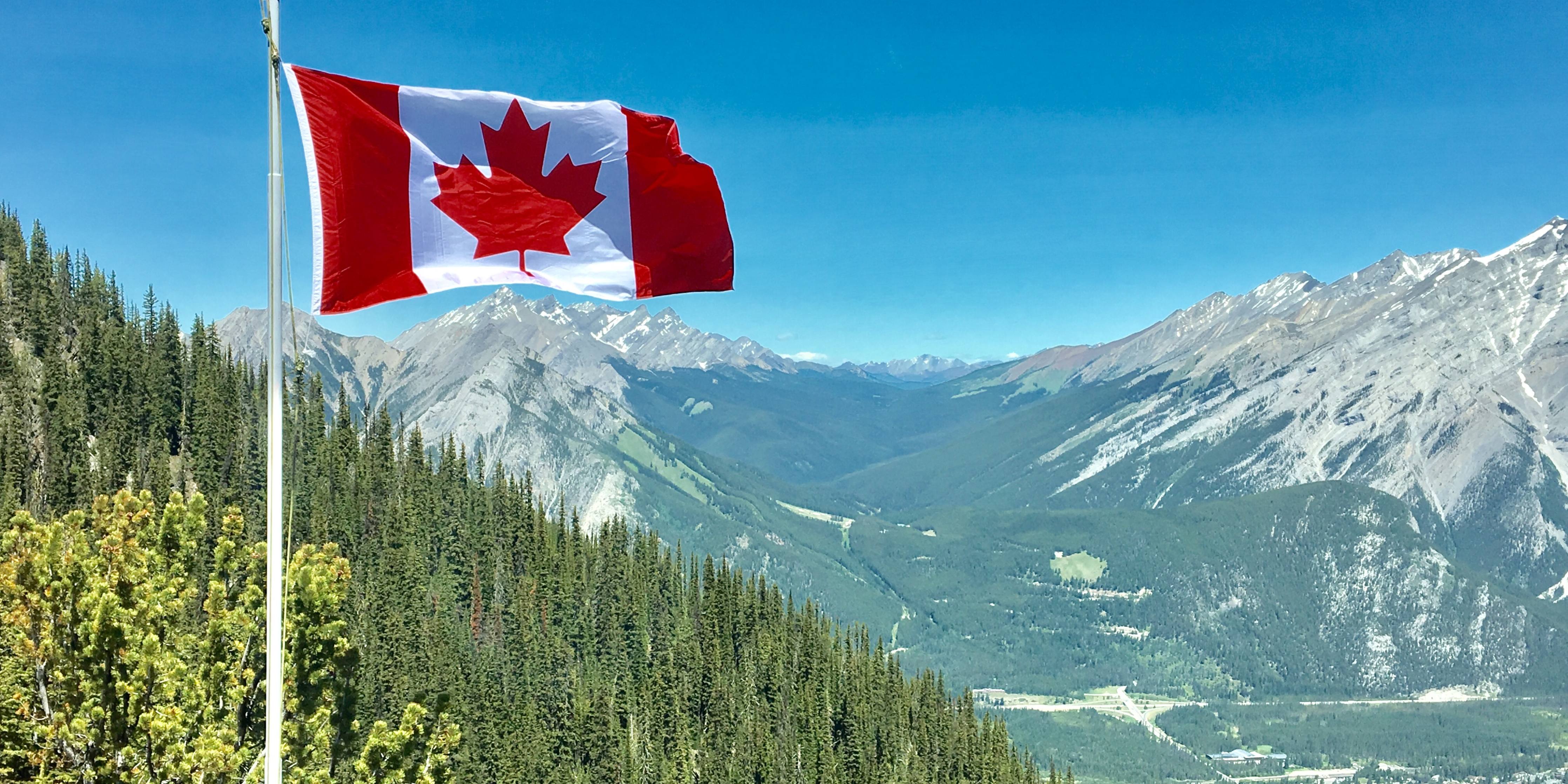 Canada flag pole on mountainside