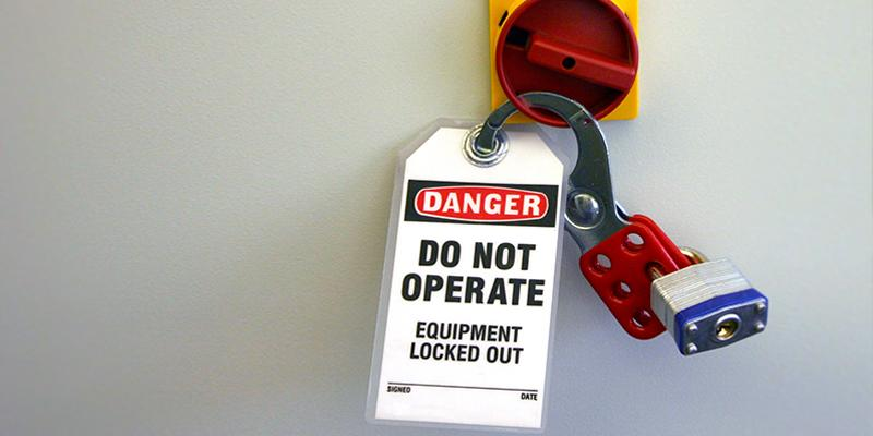 Image of a lock labeled with danger do not operate equipment locked out